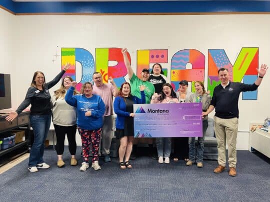 MCU staff present a donation to the staff of the Boys & Girls Clubs of Cascade County